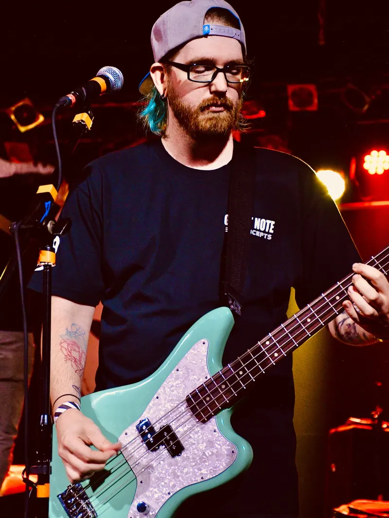 Bassist with a teal bass