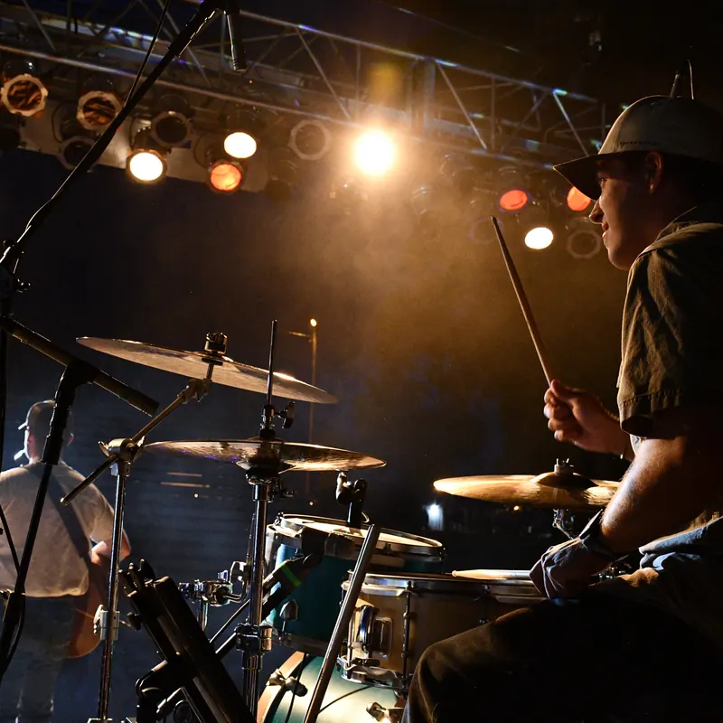 Drummer under the stage truss lights