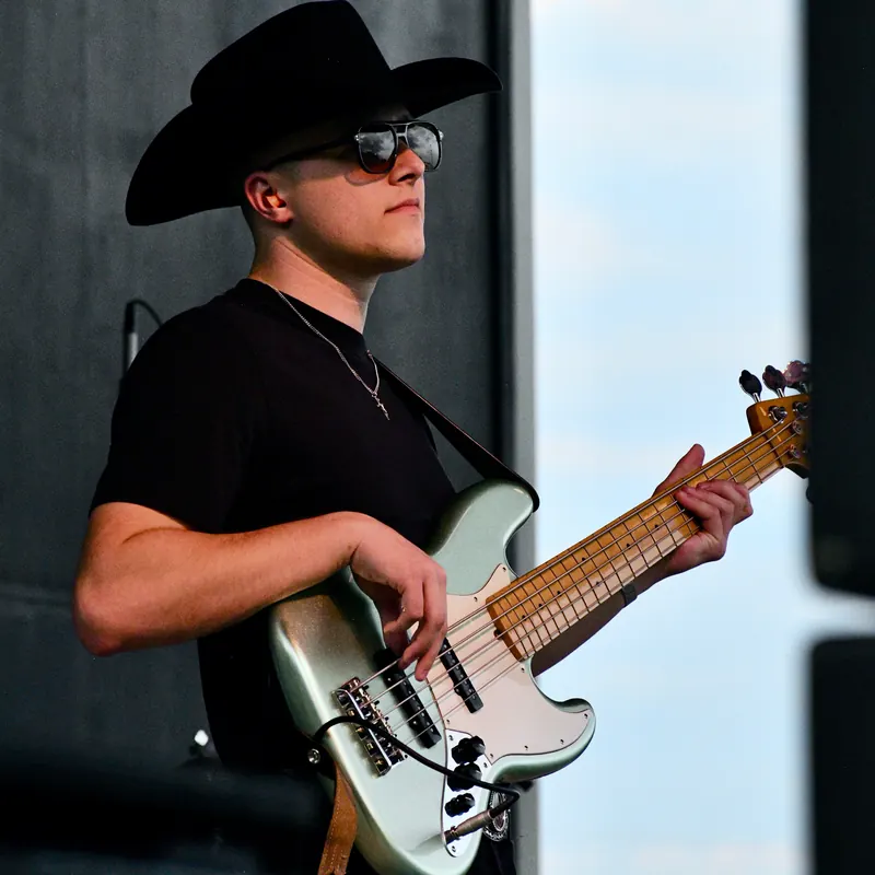 Bassist in a cowboy hat and sunglasses