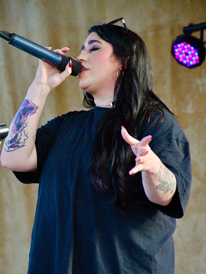 Singer at the microphone during an outdoor daytime set